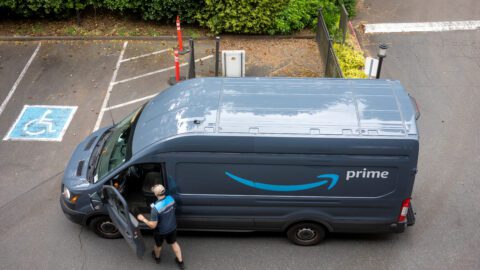 An Amazon delivery driver and truck.