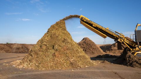 A machine mixes green waste and depackaged food waste to start the composting process at one of Denali's facilities in Phoenix, Arizona.