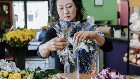 A florist prepares an order for 1-800-Flowers.com.